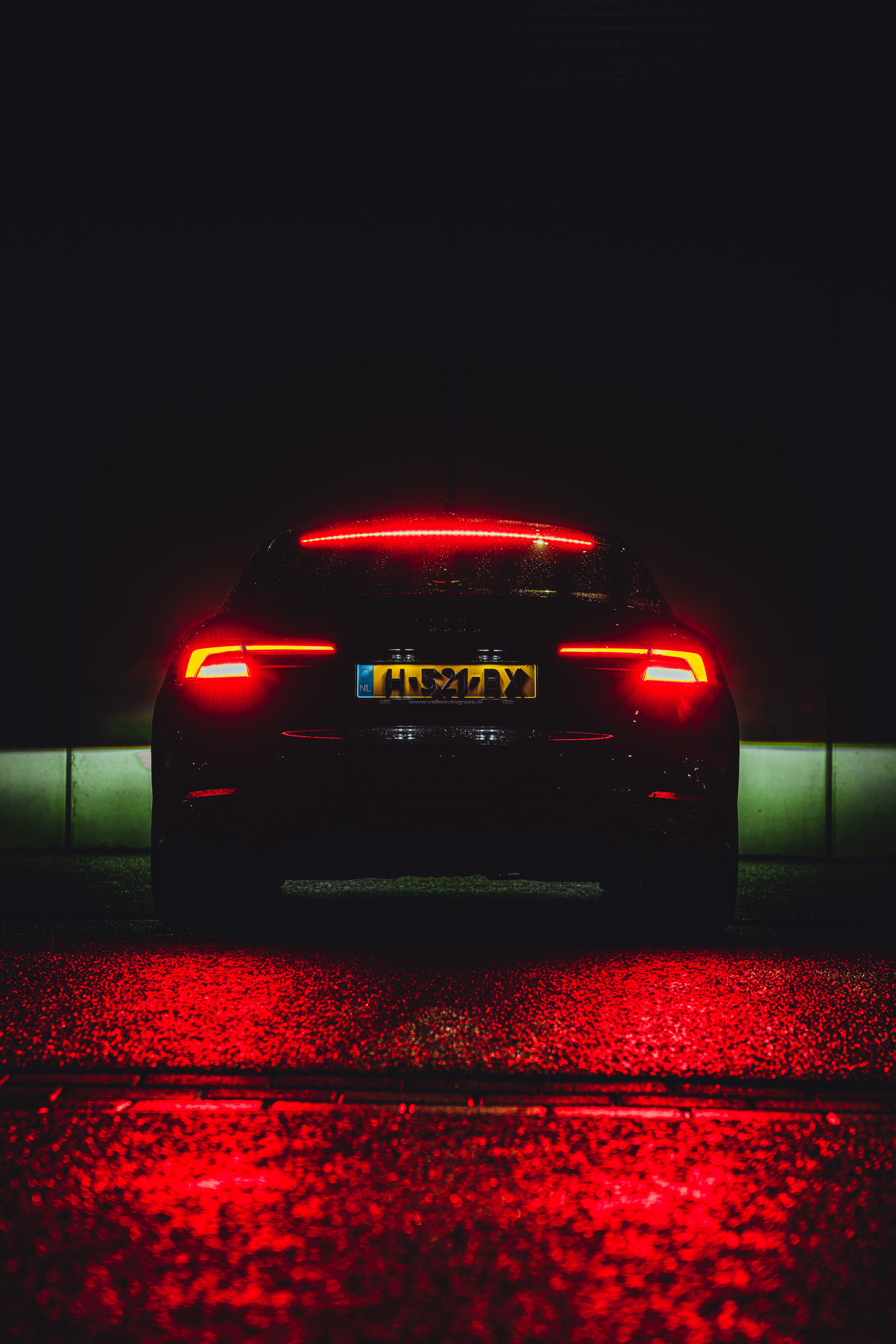 black car on red road